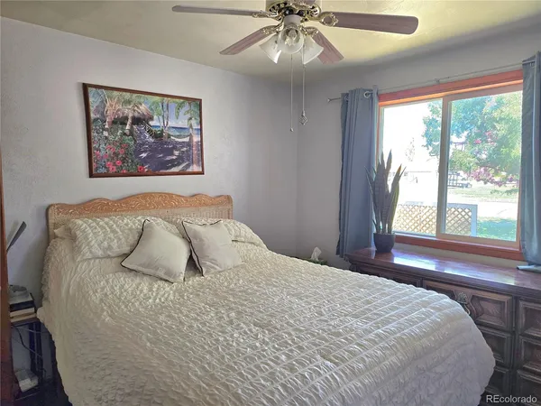 a bedroom with a large bed and a window