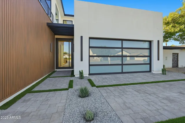 a kitchen with stainless steel appliances granite countertop a sink and a refrigerator