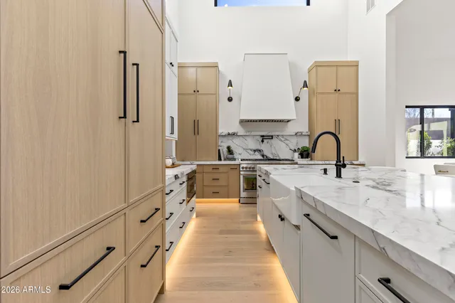 a living room with fireplace furniture and a large window