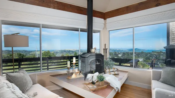 a living room with couch and a floor to ceiling window