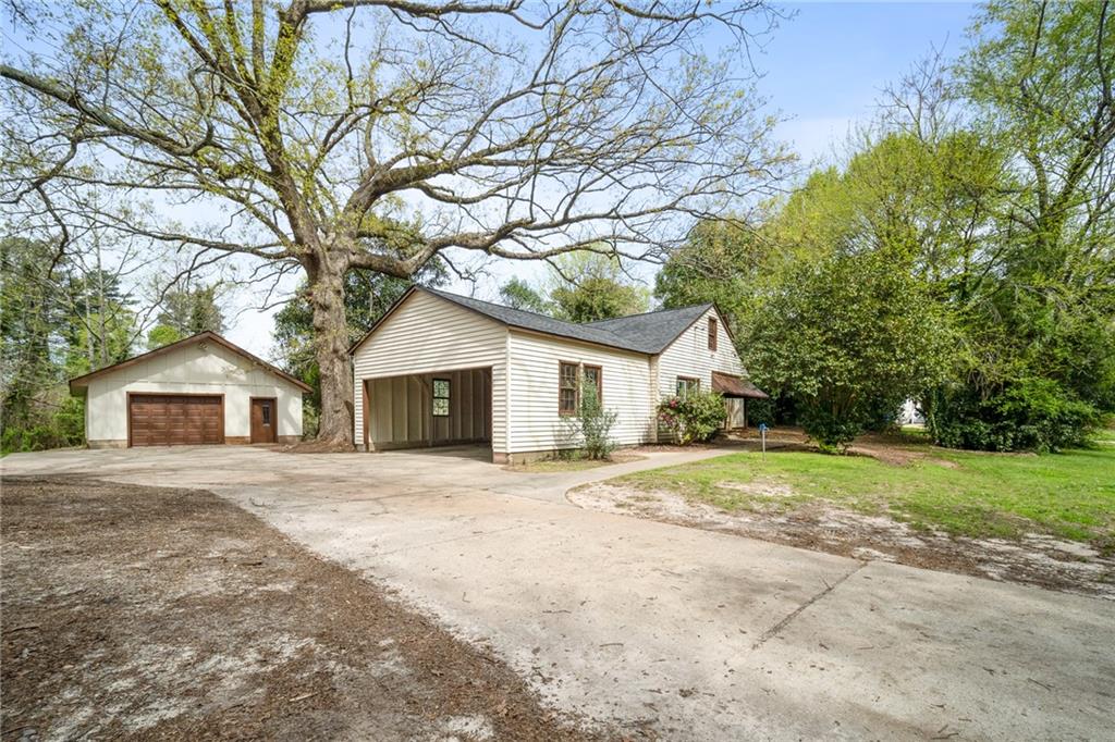 4158 Mercer Road Decatur, GA 30035 - Photo 1 of 1 a white house that has a tree in front of it