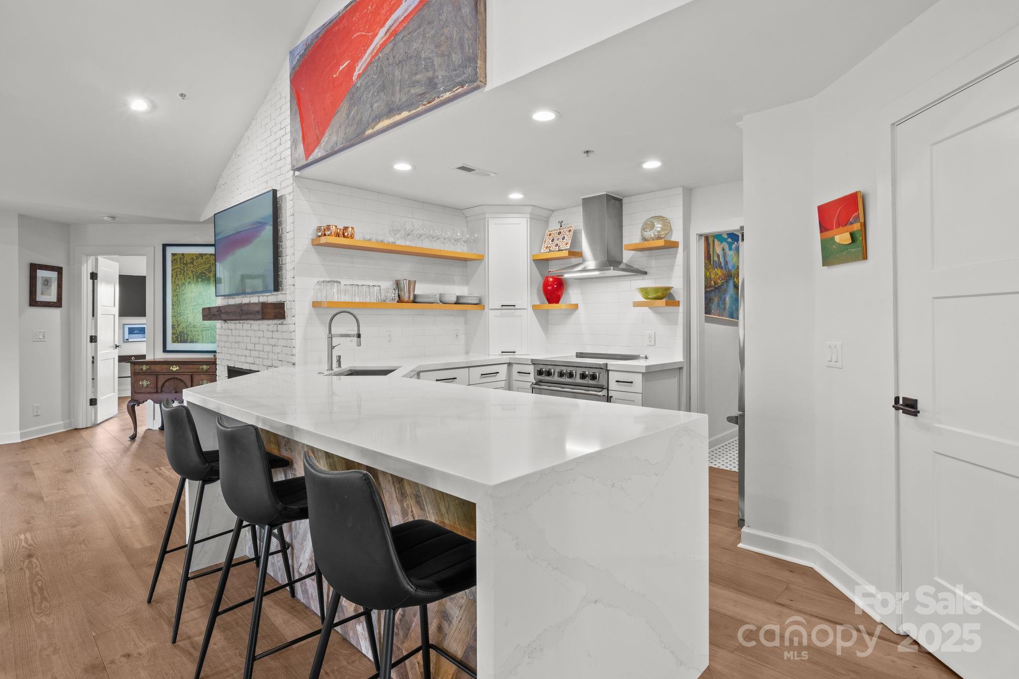 950 Jetton Street, Unit 3 Davidson, NC 28036 - Photo 11 of 29 a view of kitchen with cabinets and wooden floor