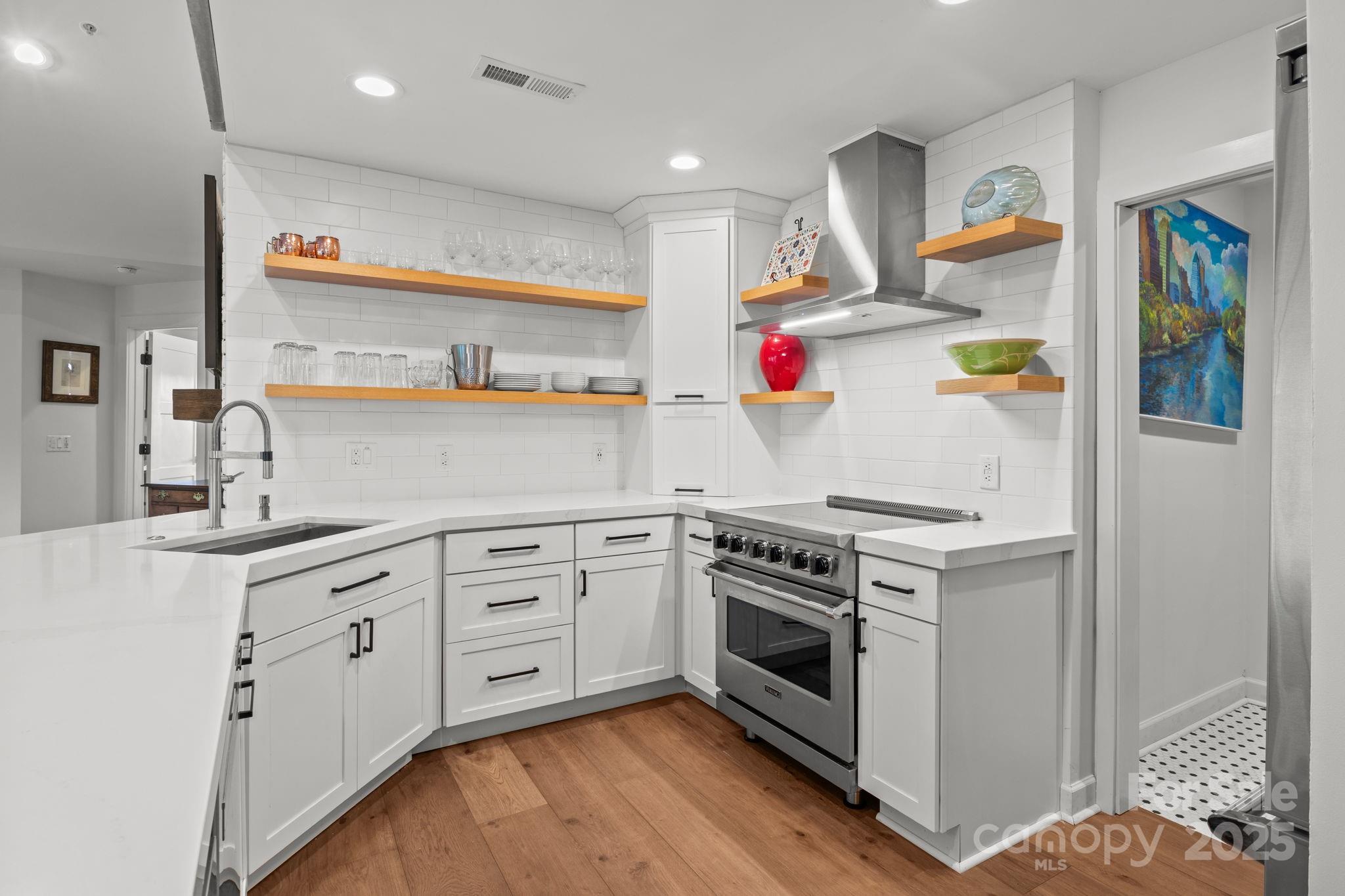 950 Jetton Street, Unit 3 Davidson, NC 28036 - Photo 13 of 29 a kitchen with stainless steel appliances granite countertop a sink stove and refrigerator