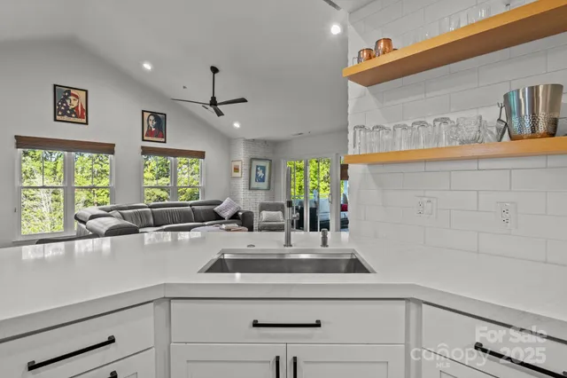 a kitchen with a sink and a large window