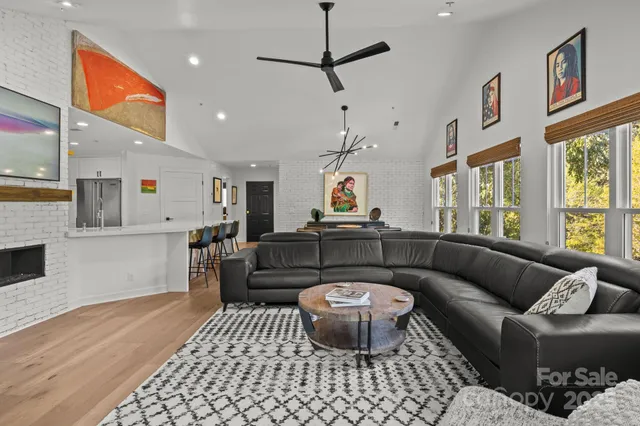 a bed sitting in a spacious bedroom next to a window