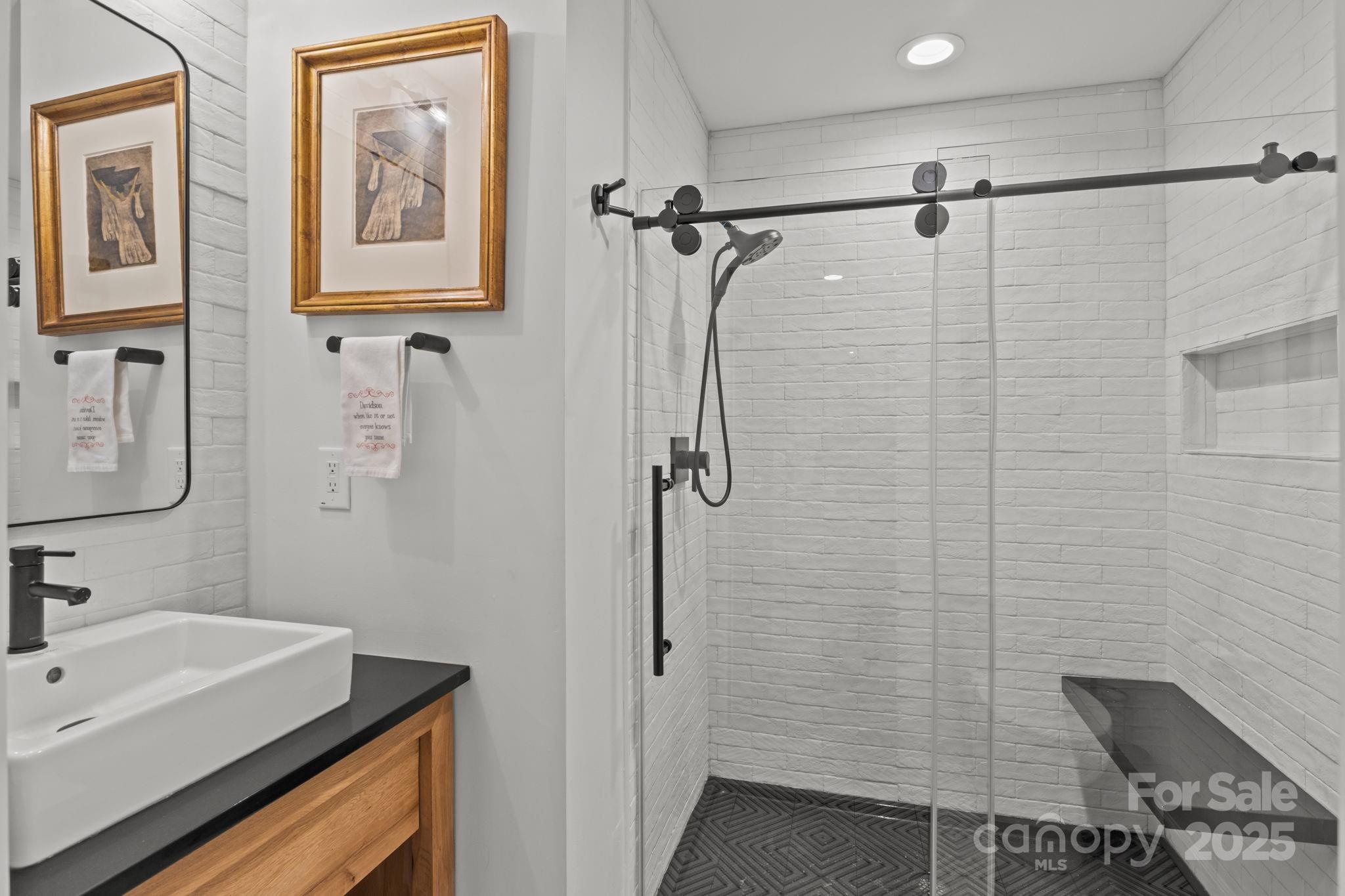 950 Jetton Street, Unit 3 Davidson, NC 28036 - Photo 6 of 29 a bathroom with a sink and a shower