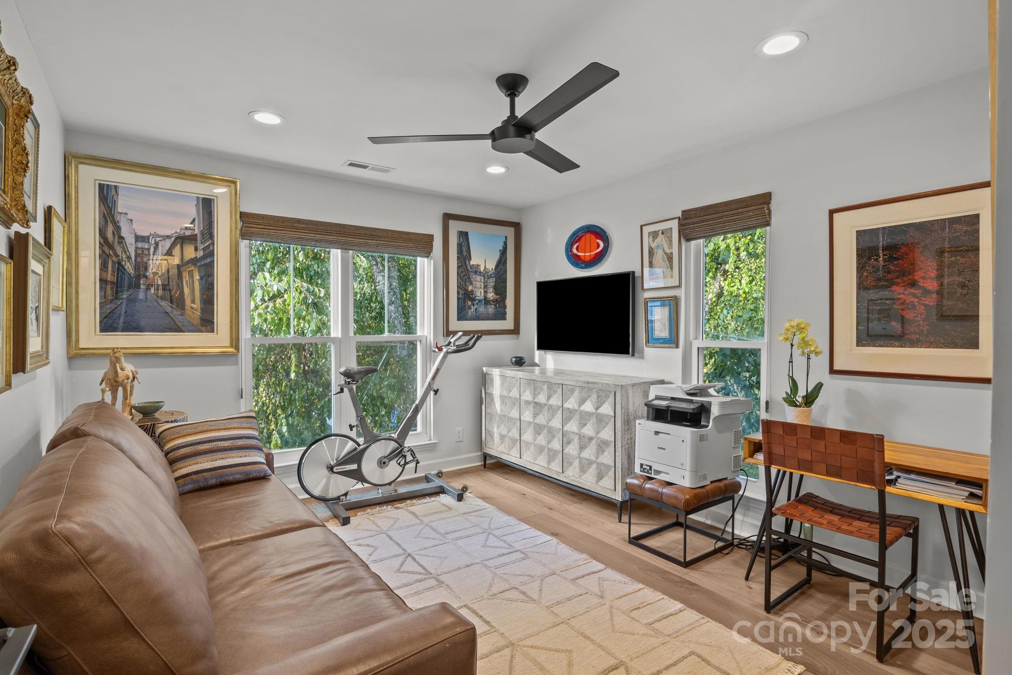 950 Jetton Street, Unit 3 Davidson, NC 28036 - Photo 7 of 29 a living room with furniture and a flat screen tv