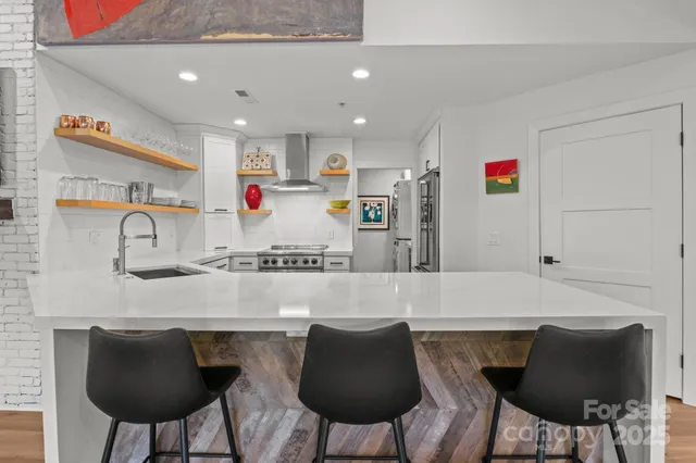 a kitchen with kitchen island cabinets and chairs