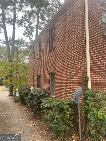 a front view of a house with plants