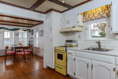 79 Old Farm Road Centerville, MA 02632 - Photo 7 of 17 a kitchen with stainless steel appliances white cabinets and wooden floors