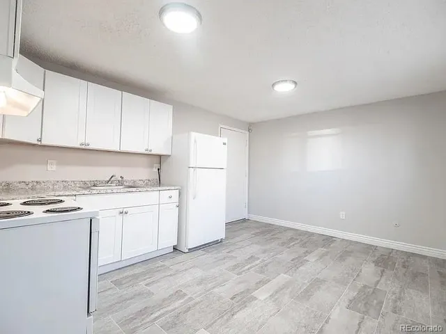 a kitchen with granite countertop cabinets stainless steel appliances and a sink
