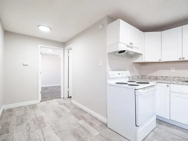 a kitchen with stainless steel appliances granite countertop a stove and a refrigerator