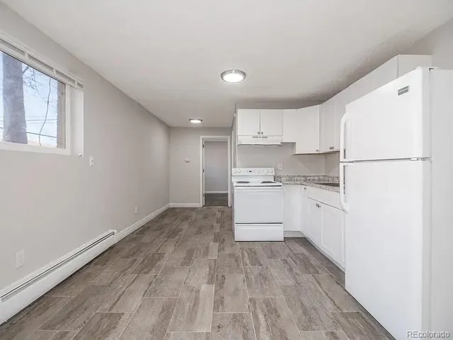 a kitchen with white cabinets and white appliances