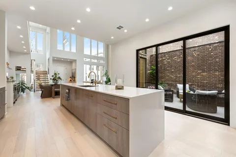 a large white kitchen with a large window