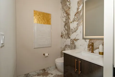 a bathroom with a sink a toilet and shower curtain