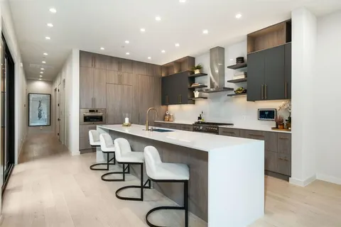a kitchen with stainless steel appliances kitchen island granite countertop a sink and cabinets