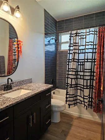 a bathroom with a sink toilet and shower