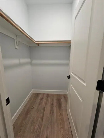 a view of a room with wooden floor and staircase