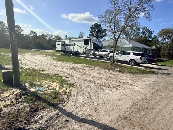 a view of a house with pool and sitting area