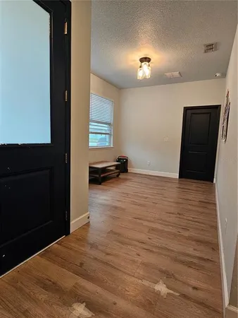 a view of a livingroom with wooden floor and a ceiling fan
