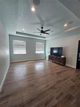 a view of livingroom with hardwood floor and a ceiling fan