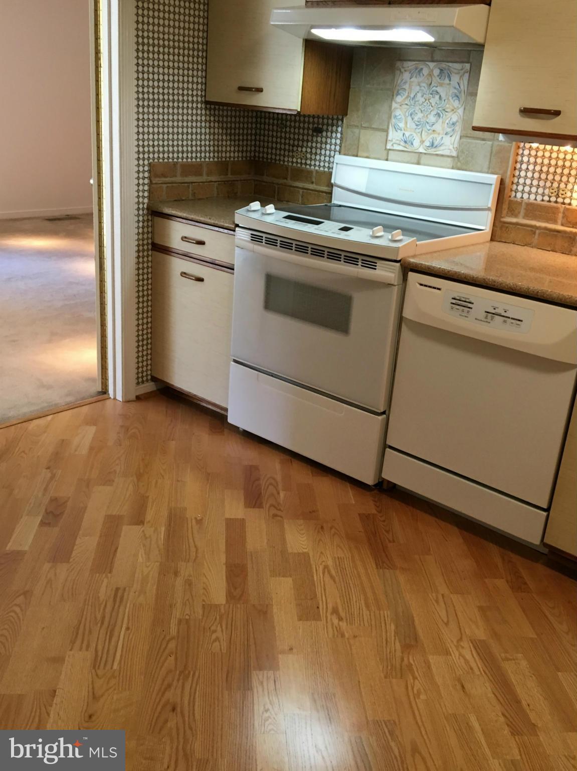 2331 Old Court Road, Unit 400 Baltimore, MD 21208 - Photo 13 of 27 a stove top oven sitting inside of a kitchen