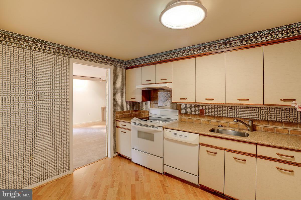 2331 Old Court Road, Unit 400 Baltimore, MD 21208 - Photo 2 of 27 a kitchen with a sink cabinets and appliances