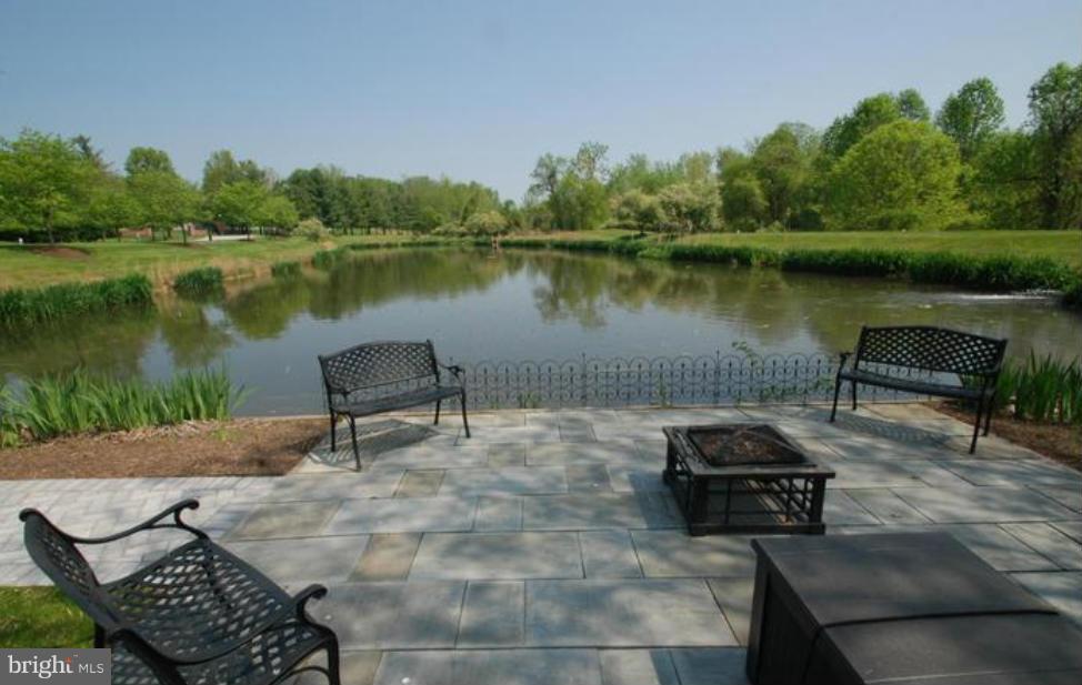 2331 Old Court Road, Unit 400 Baltimore, MD 21208 - Photo 25 of 27 a view of a lake with tables and chairs