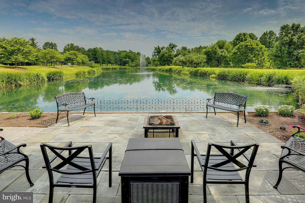 2331 Old Court Road, Unit 400 Baltimore, MD 21208 - Photo 26 of 27 a view of a lake with table and chairs