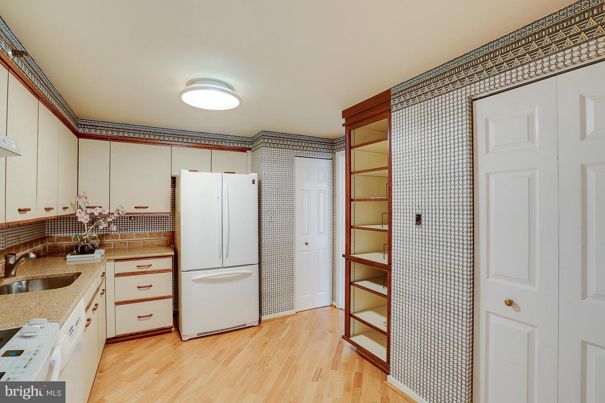 2331 Old Court Road, Unit 400 Baltimore, MD 21208 - Photo 3 of 27 a kitchen with stainless steel appliances a refrigerator and a stove top oven