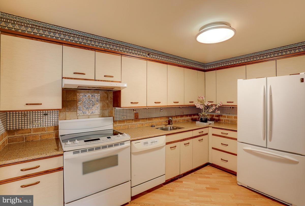 2331 Old Court Road, Unit 400 Baltimore, MD 21208 - Photo 4 of 27 a kitchen with cabinets appliances a sink and a window