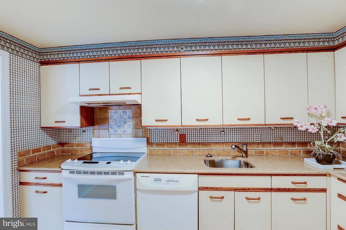 2331 Old Court Road, Unit 400 Baltimore, MD 21208 - Photo 5 of 27 a kitchen with stainless steel appliances granite countertop a sink stove and cabinets