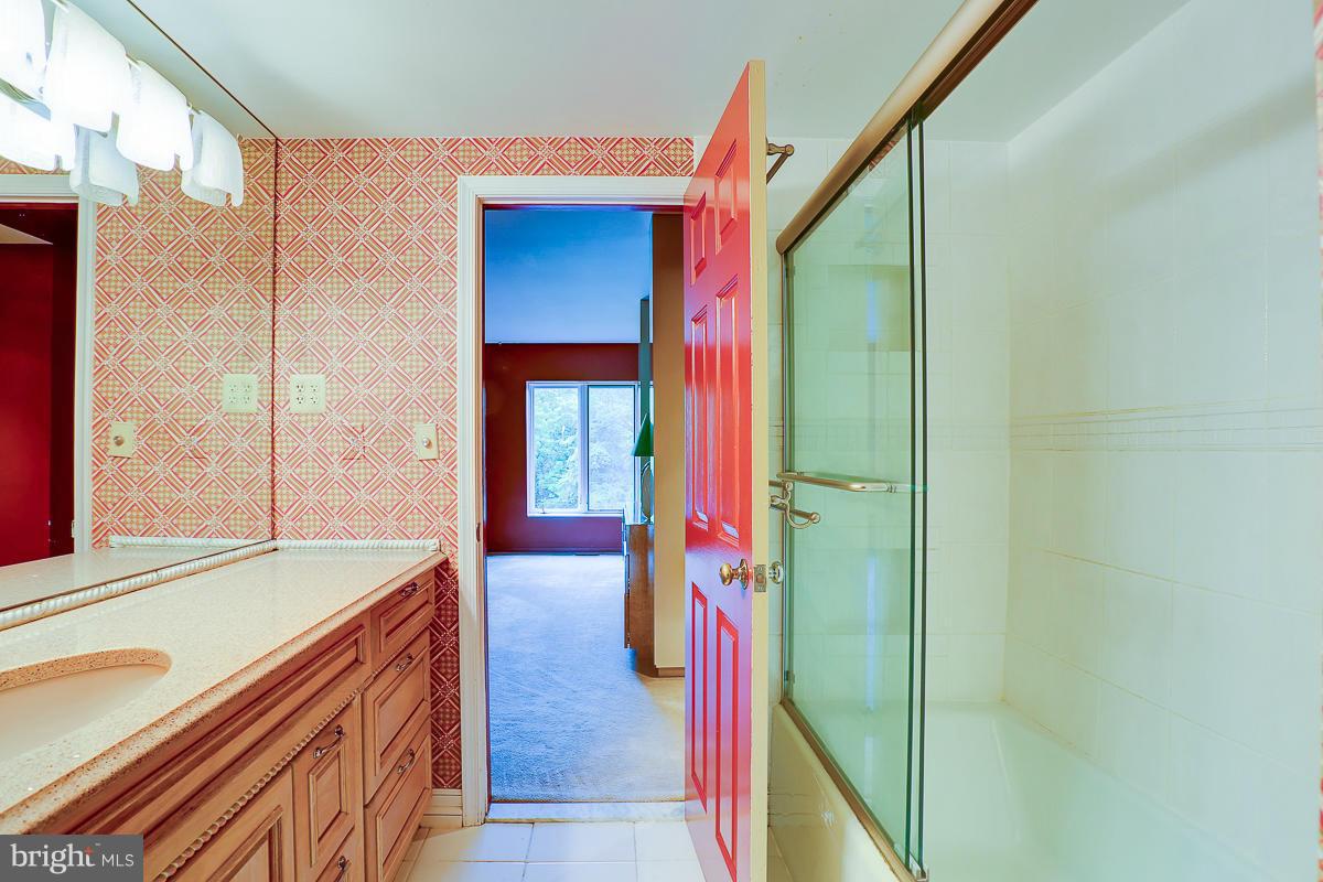 2331 Old Court Road, Unit 400 Baltimore, MD 21208 - Photo 6 of 27 a hall with a sink and a mirror