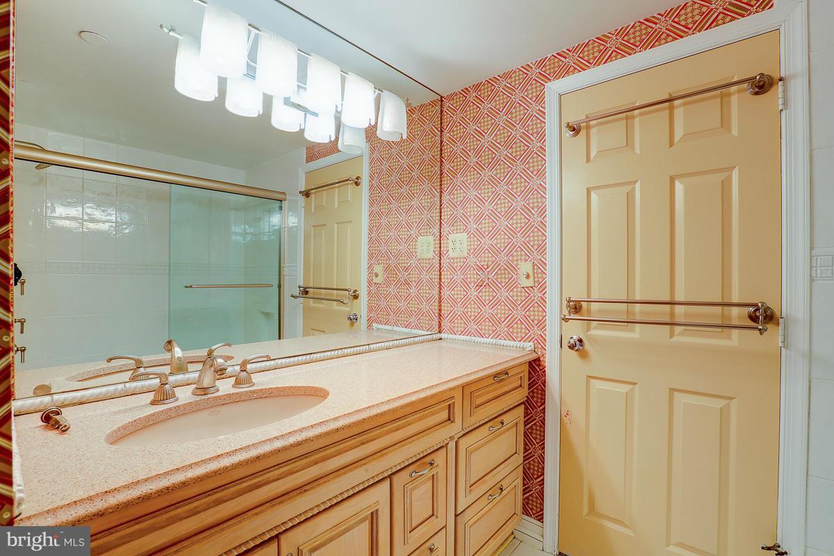 2331 Old Court Road, Unit 400 Baltimore, MD 21208 - Photo 7 of 27 a bathroom with a sink and a mirror