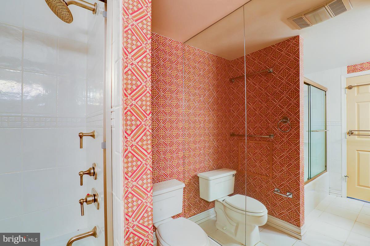 2331 Old Court Road, Unit 400 Baltimore, MD 21208 - Photo 8 of 27 a bathroom with a toilet and a shower curtain