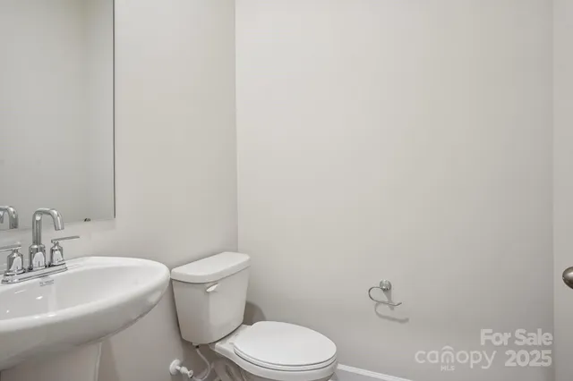 a white toilet sitting next to a bathroom sink