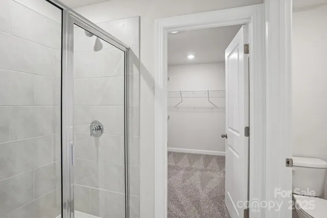 a bathroom with a shower and a mirror