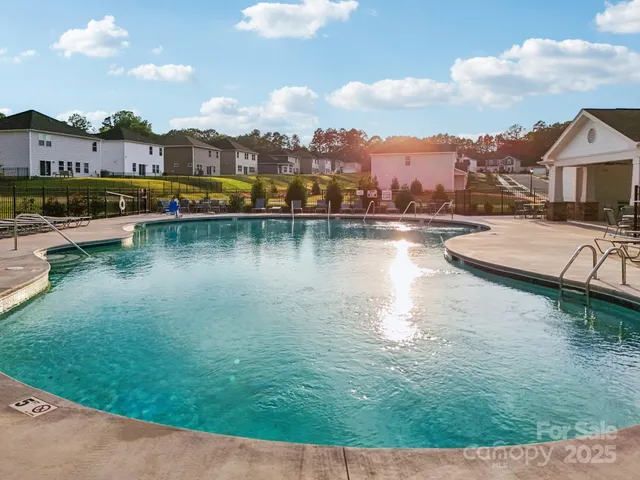 an aerial view of residential houses with outdoor space and lake view
