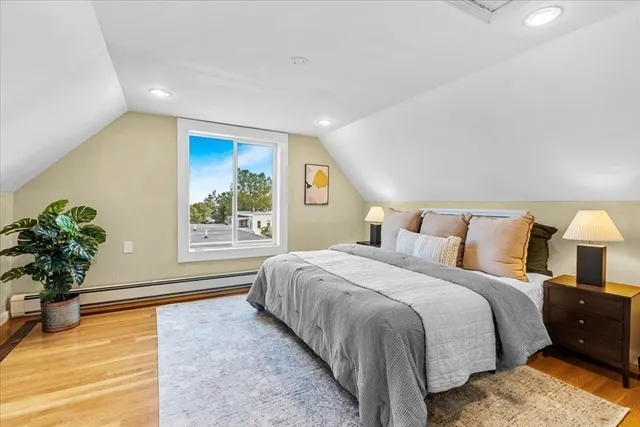 a spacious bedroom with a bed and a potted plant