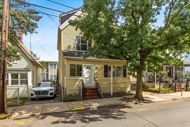 a view of a car park in front of a house