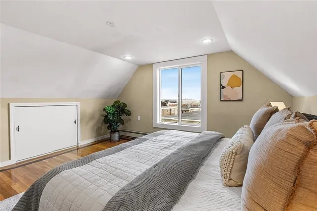 a bedroom with a bed and a window