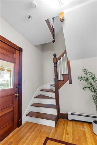 a view of entryway and hall with wooden floor