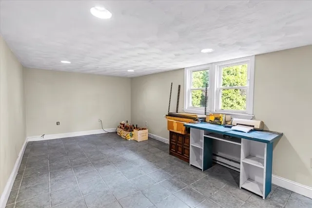 a room with a wooden table and chairs