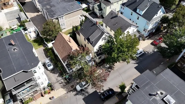 an aerial view of multiple houses with yard