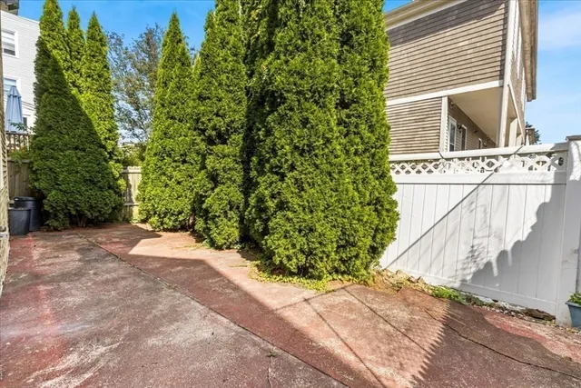 a view of a house with a yard and pathway