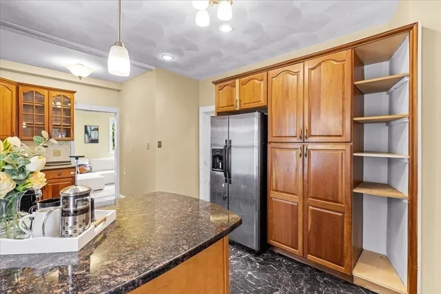 a kitchen with stainless steel appliances granite countertop a refrigerator and a sink