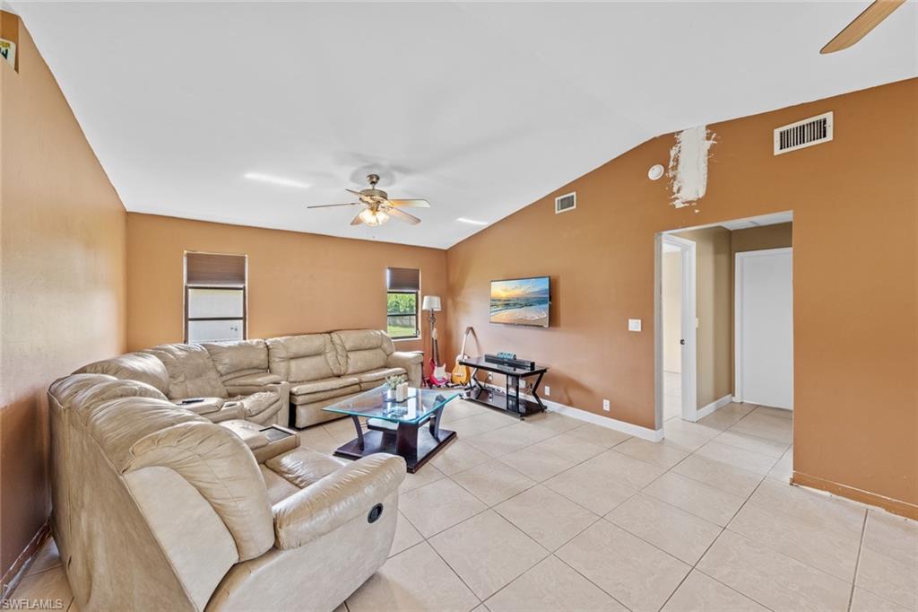 17452 Braddock Road Fort Myers, FL 33967 - Photo 20 of 38 Tiled living room with lofted ceiling and ceiling fan
