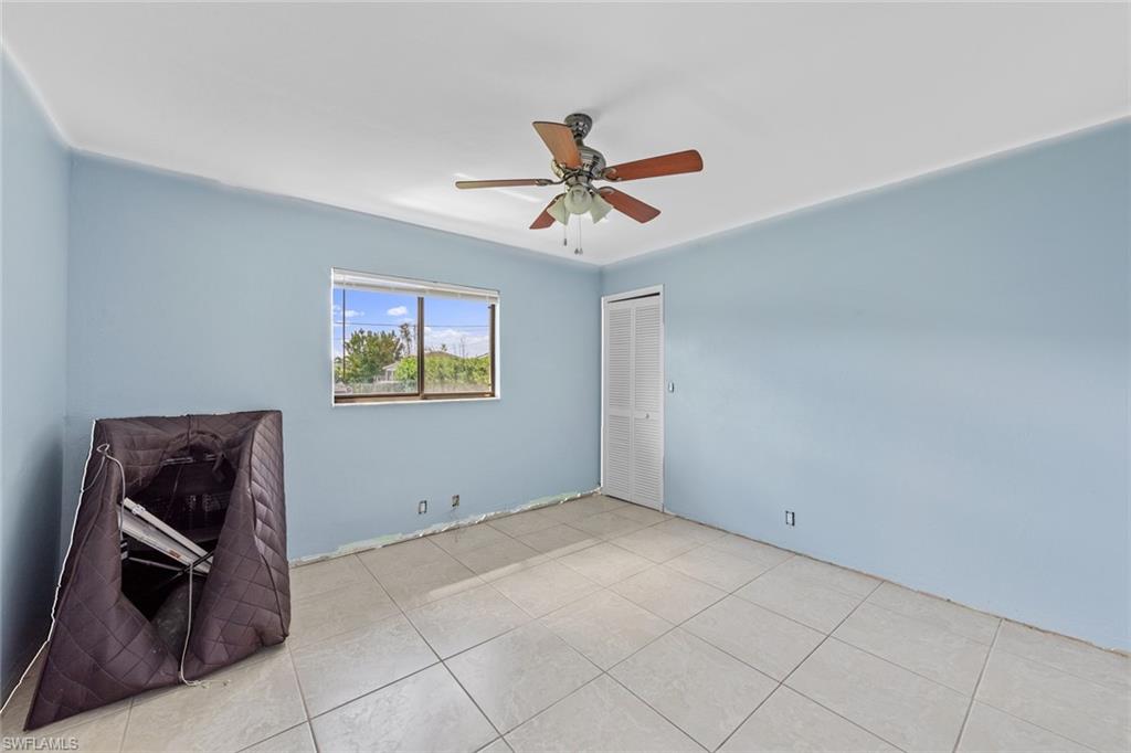 17452 Braddock Road Fort Myers, FL 33967 - Photo 31 of 38 Empty room featuring ceiling fan and light tile patterned floors