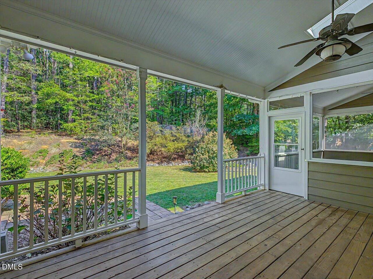 450 Ryan Road Pittsboro, NC 27312 - Photo 27 of 73 Covered Screened Porch Featuring White Railing, and Outdoor Ceiling Fan Fixture
