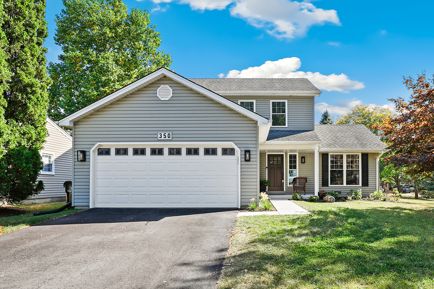350 Pearson Circle Naperville, IL 60563 - Photo 1 of 32 a view of a white house with a yard plants and large tree